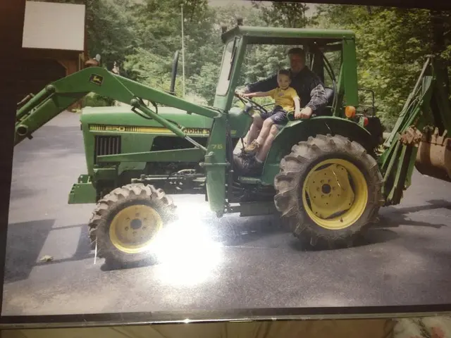 Young Kevin learning the business on a John Deere tractor